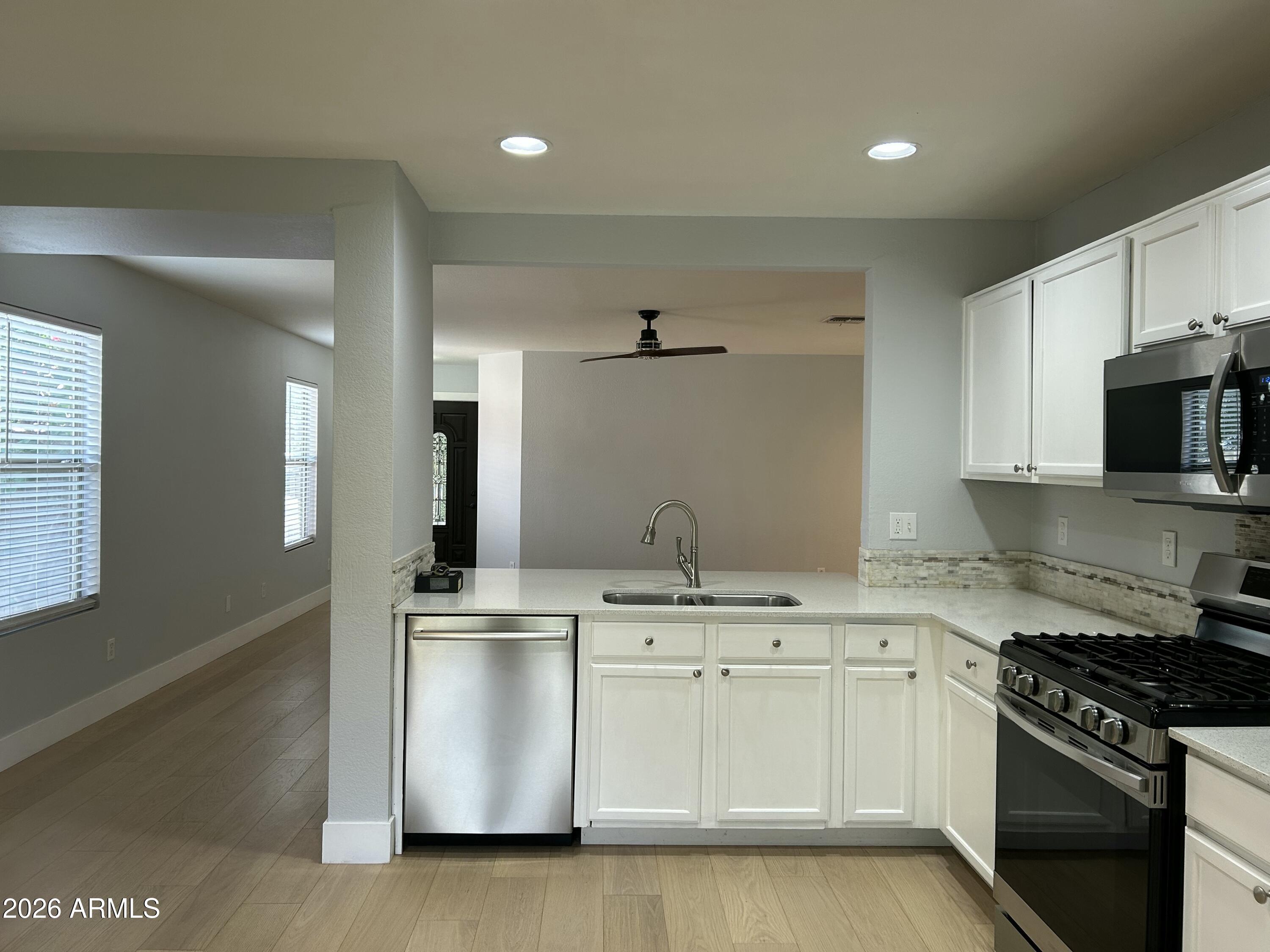 3216 West Mark Lane Phoenix, AZ 85083 - Photo 5 of 23 a kitchen with a sink stove and microwave