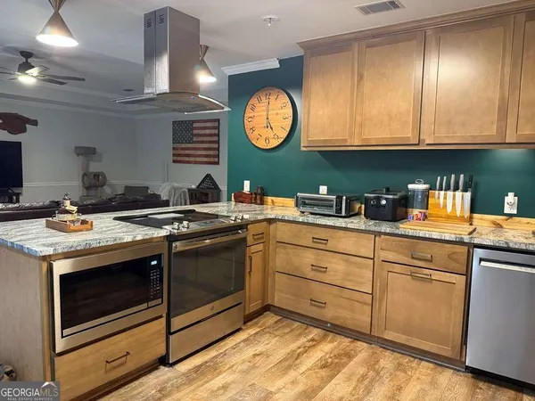 a kitchen with cabinets and stainless steel appliances