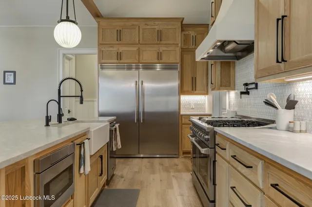 a kitchen with cabinets appliances and a counter space