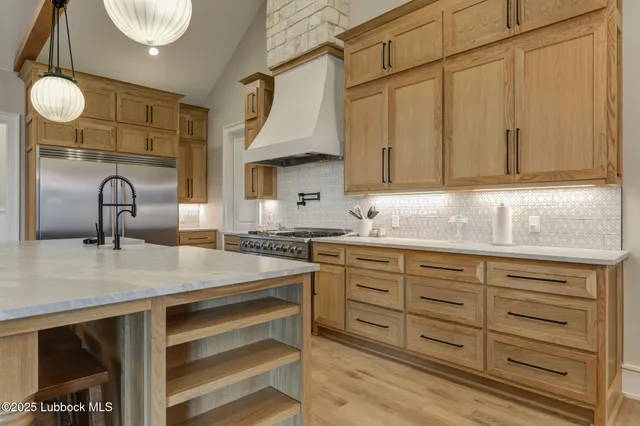 a kitchen with stainless steel appliances granite countertop a stove and a sink