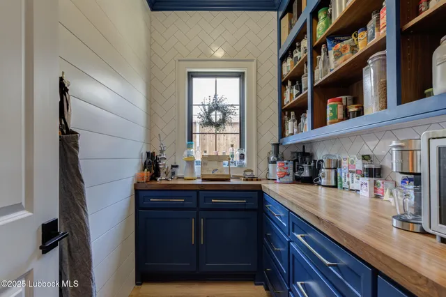 a kitchen with cabinets and window