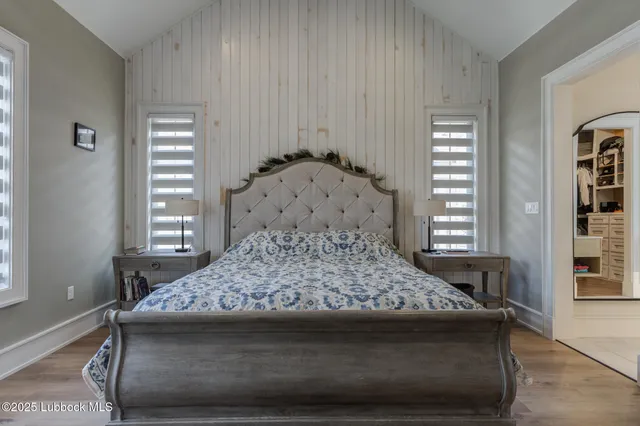 a spacious bathroom with a tub sink and mirror