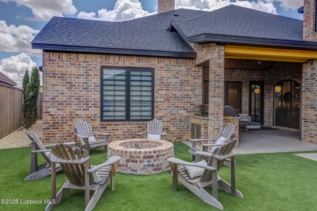 a outdoor living space with furniture and a fireplace
