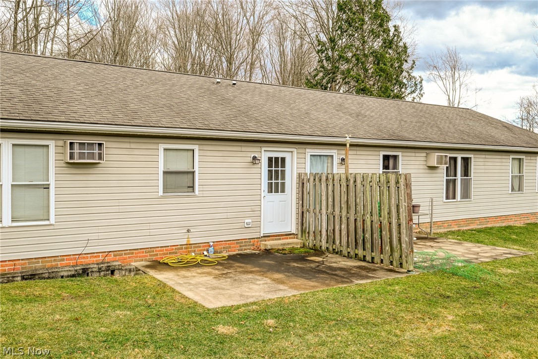 8464-8446 Tallmadge Road Diamond, OH 44412 - Photo 23 of 39 Rear view of property featuring a patio, a shingled roof, and a lawn