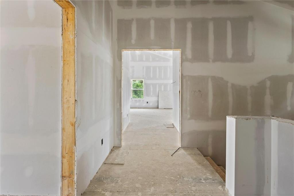6848 Silver Maple Drive Rex, GA 30273 - Photo 9 of 38 a view of a hallway with a cabinet and a refrigerator