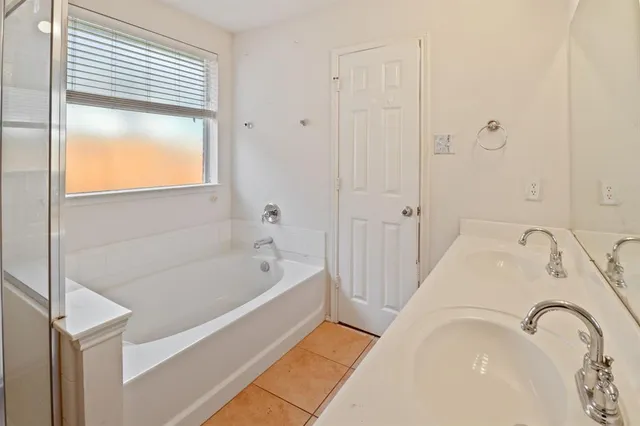 a bathroom with a tub sink and vanity