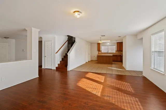 a view of a room with wooden floor and stairs
