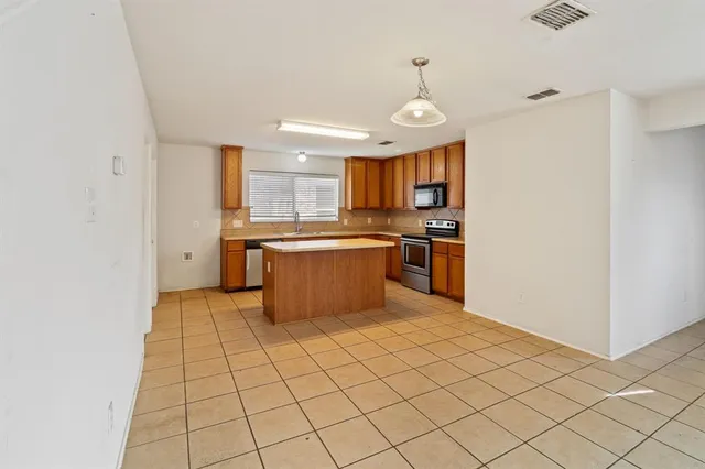 a kitchen with stainless steel appliances cabinets a sink and a stove