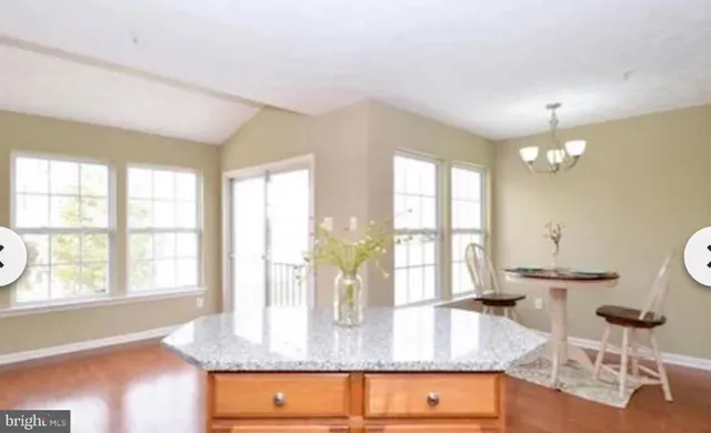 a view of kitchen and dining room with wooden floor