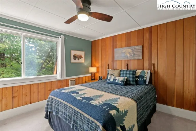 a bedroom with a large bed and a window