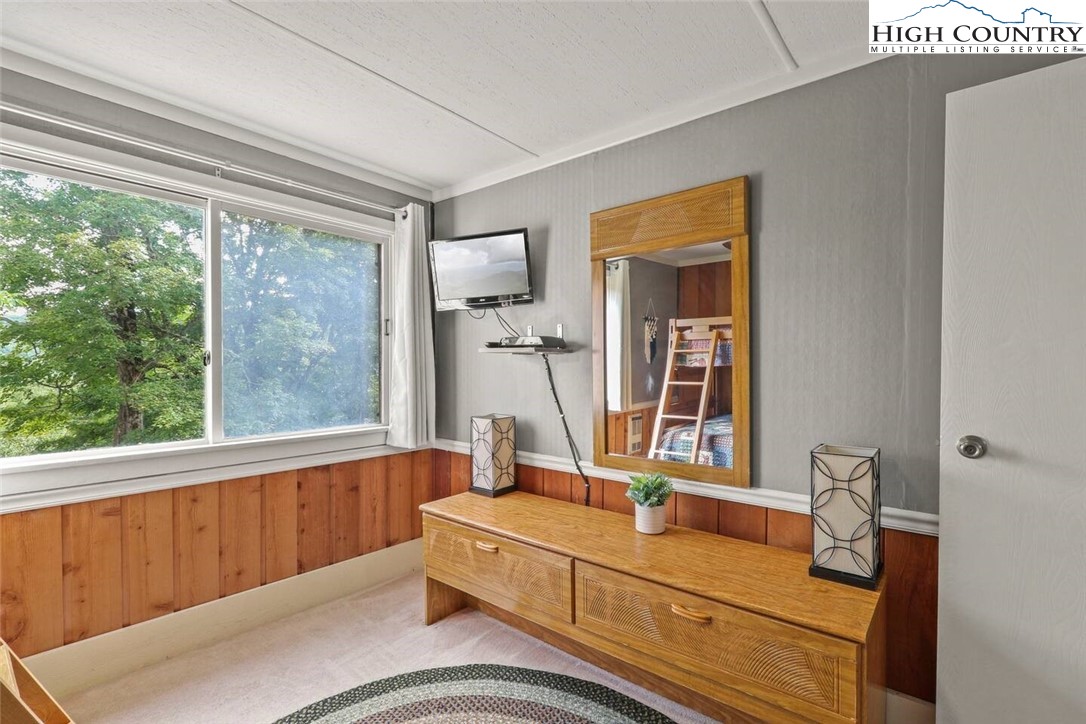 220 Charter Hills Road, Unit B1 Beech Mountain, NC 28604 - Photo 16 of 26 a living room with furniture and a large window