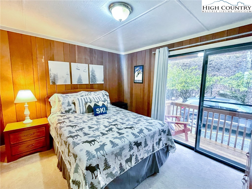 220 Charter Hills Road, Unit B1 Beech Mountain, NC 28604 - Photo 20 of 26 a bedroom with a bed and a window