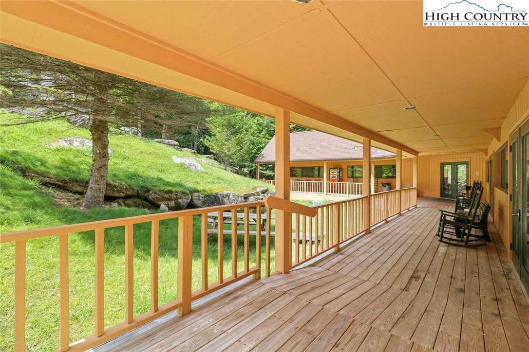 220 Charter Hills Road, Unit B1 Beech Mountain, NC 28604 - Photo 22 of 26 a view of a wooden chairs on the deck
