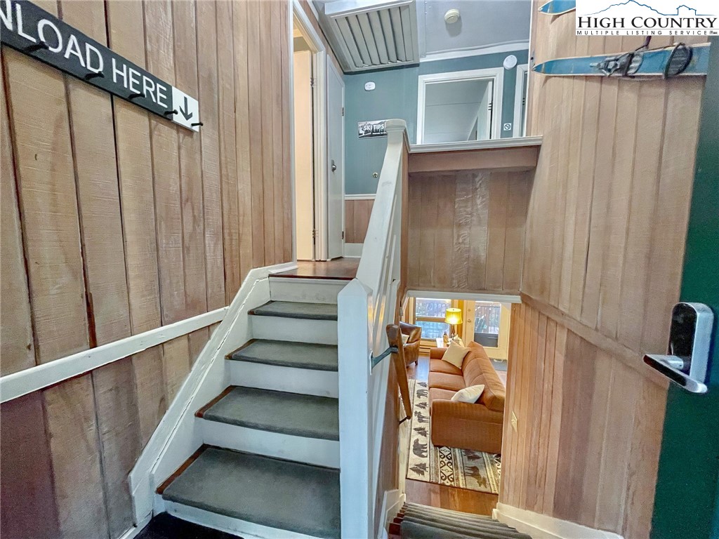 220 Charter Hills Road, Unit B1 Beech Mountain, NC 28604 - Photo 3 of 26 a view of staircase with wooden floor and chair