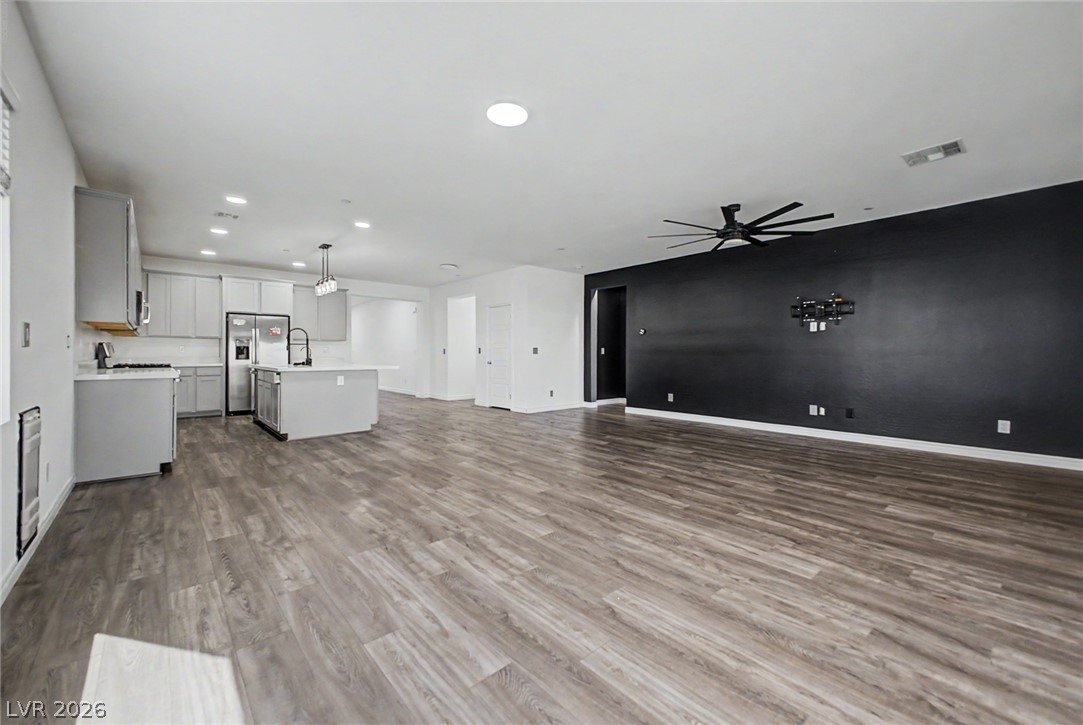 226 Augusta Ridge Henderson, NV 89015 - Photo 7 of 47 An open-concept living area seamlessly connects a modern kitchen and spacious living room.