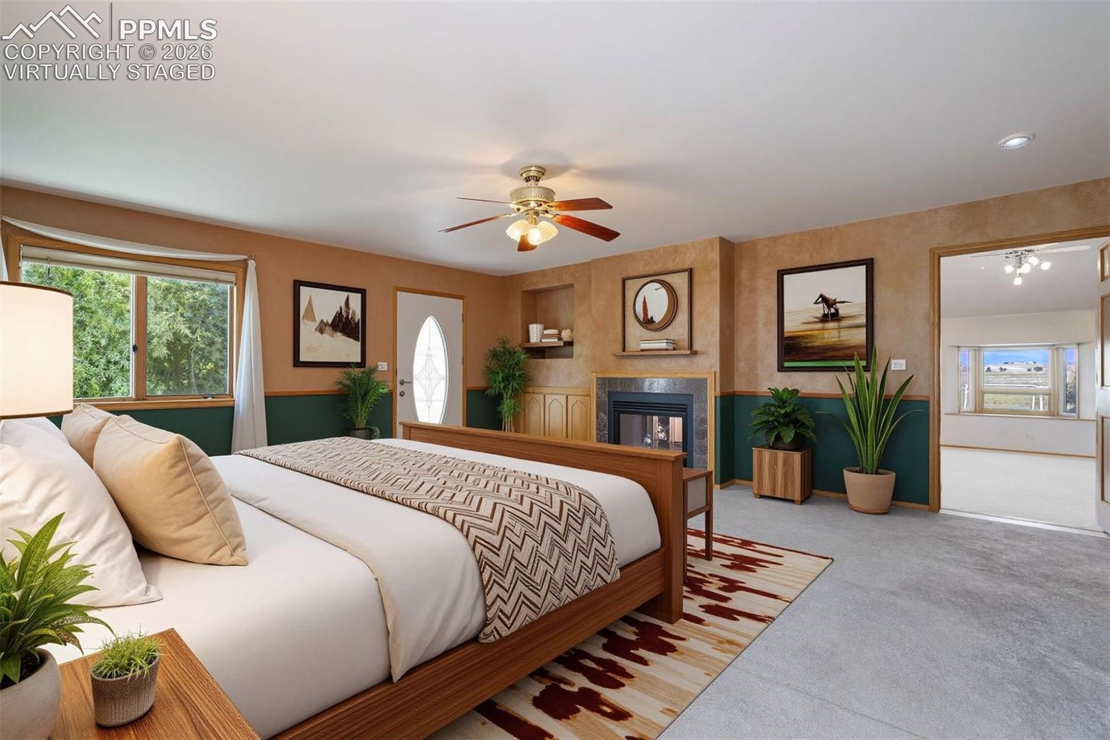 2550 Slocum Road Peyton, CO 80831 - Photo 20 of 50 Virtually Staged Primary bedroom featuring a fireplace with tile surround, and built-in shelving