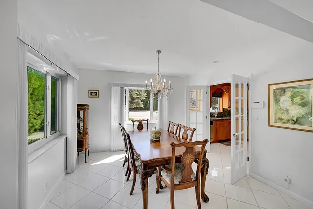 a living room with furniture a flat screen tv and kitchen view