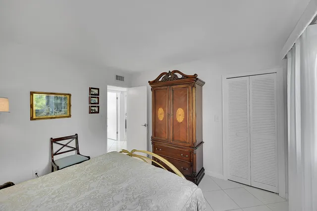 a bedroom with a large bed and a flat screen tv