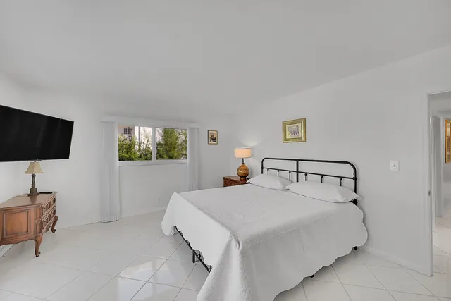 a bathroom with a granite countertop sink mirror vanity and toilet