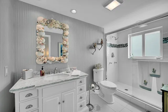 a bathroom with a sink toilet and a mirror