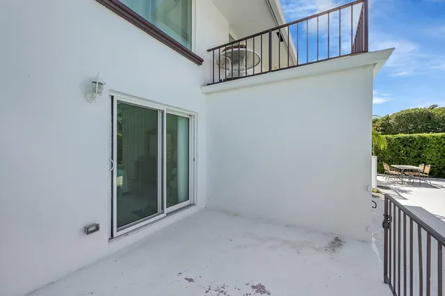 a view of a house with a yard and potted plants