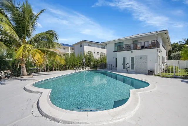 an aerial view of house with yard swimming pool and outdoor seating