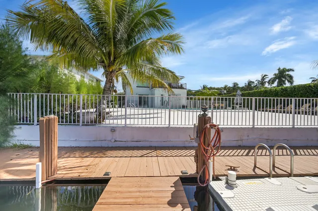 an aerial view of a house with a garden and lake view