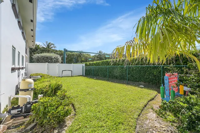 an aerial view of a house with a yard pool a patio and outdoor seating