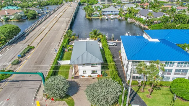 an aerial view of a house with garden space and swimming pool