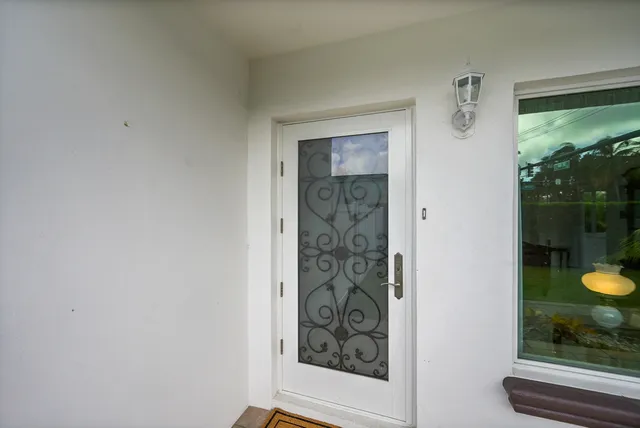 a living room with furniture and a floor to ceiling window