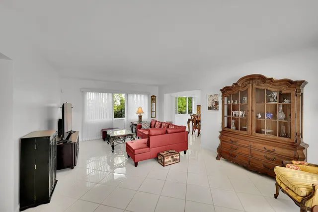 a living room with furniture a window and a flat screen tv