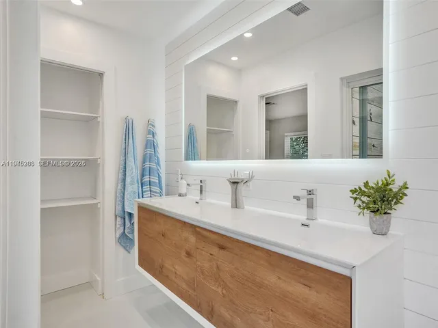 a bathroom with a sink double vanity and mirror