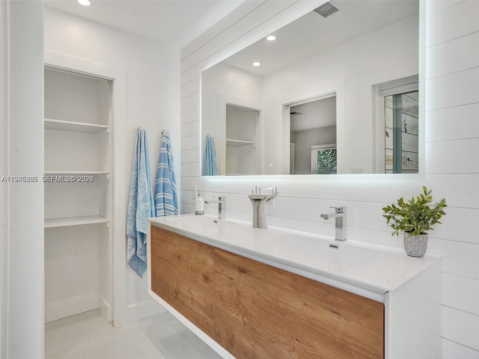 620 West Palmetto Park Road Boca Raton, FL 33486 - Photo 14 of 38 a bathroom with a sink double vanity and mirror
