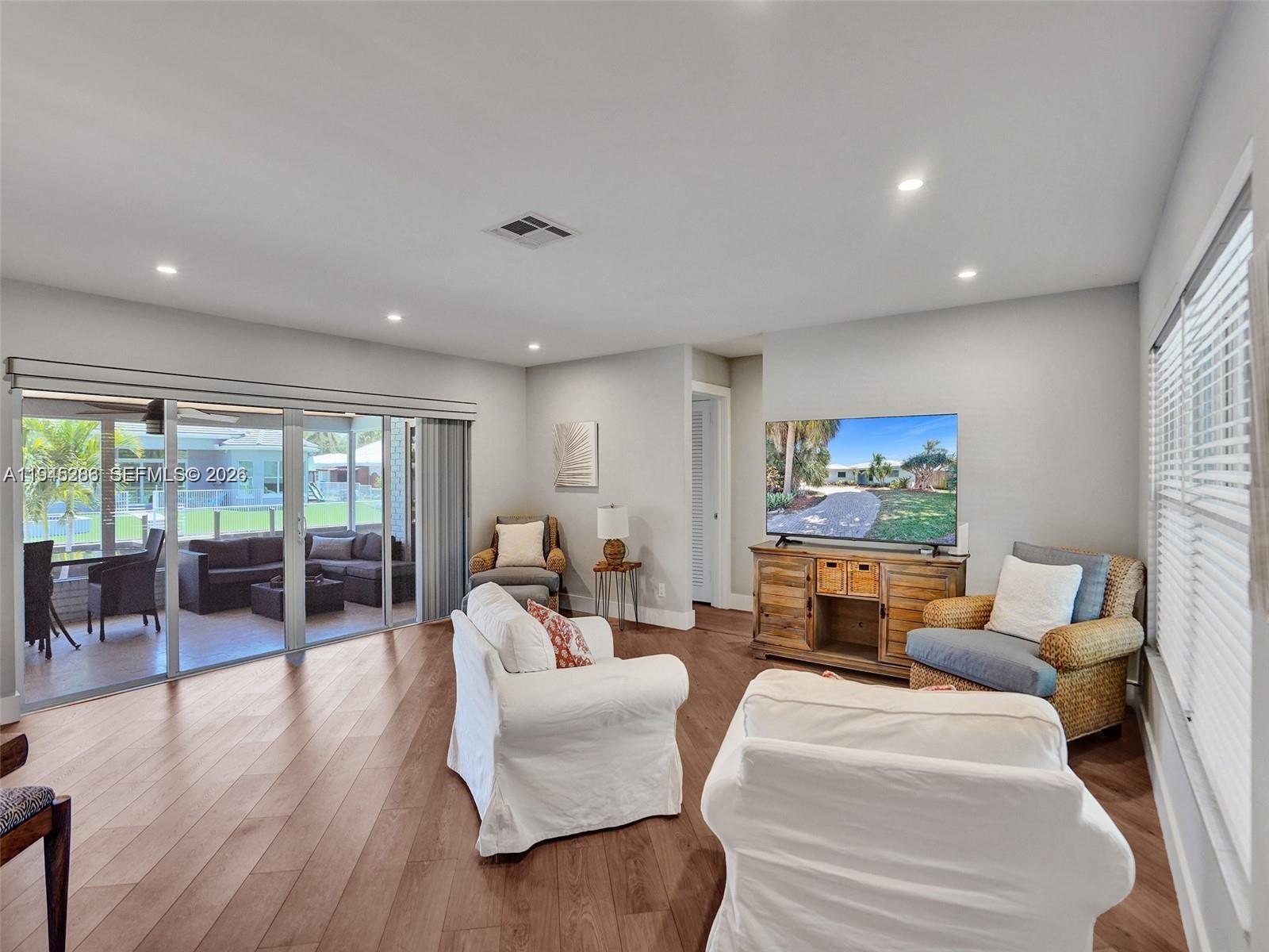 620 West Palmetto Park Road Boca Raton, FL 33486 - Photo 20 of 38 a living room with furniture two large windows and a fireplace