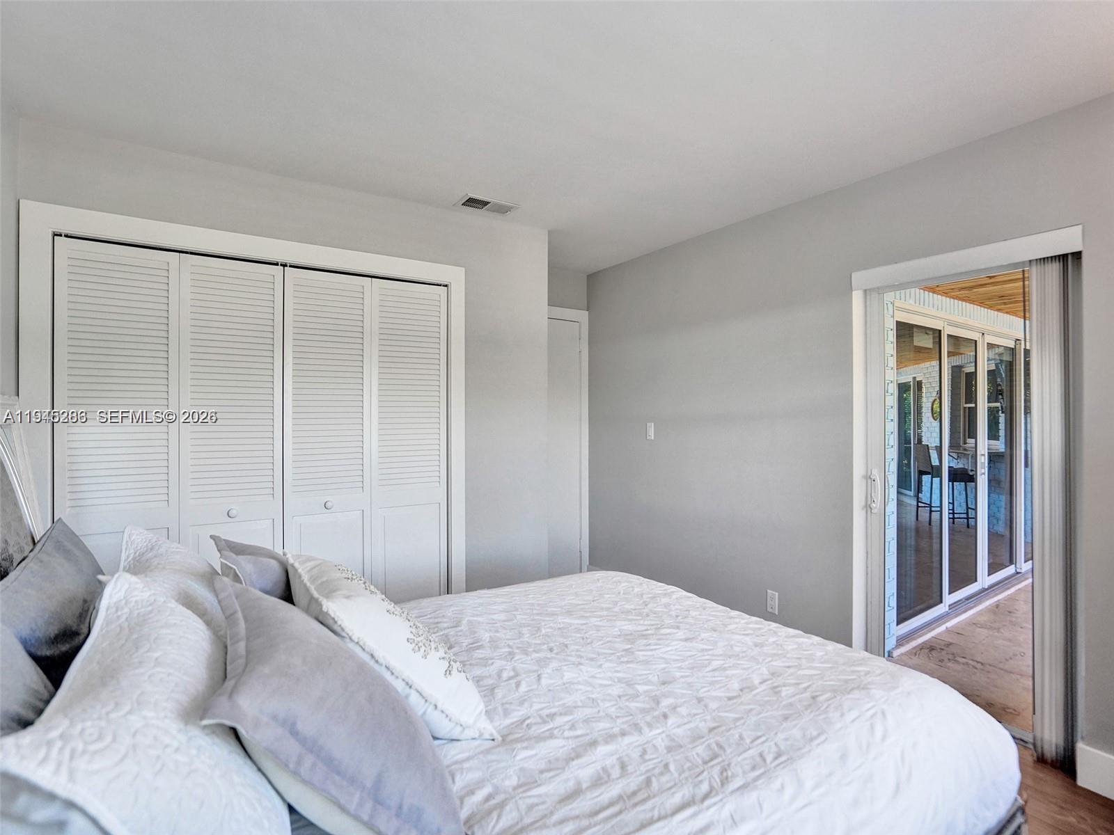 620 West Palmetto Park Road Boca Raton, FL 33486 - Photo 24 of 38 a bedroom with a bed and a window