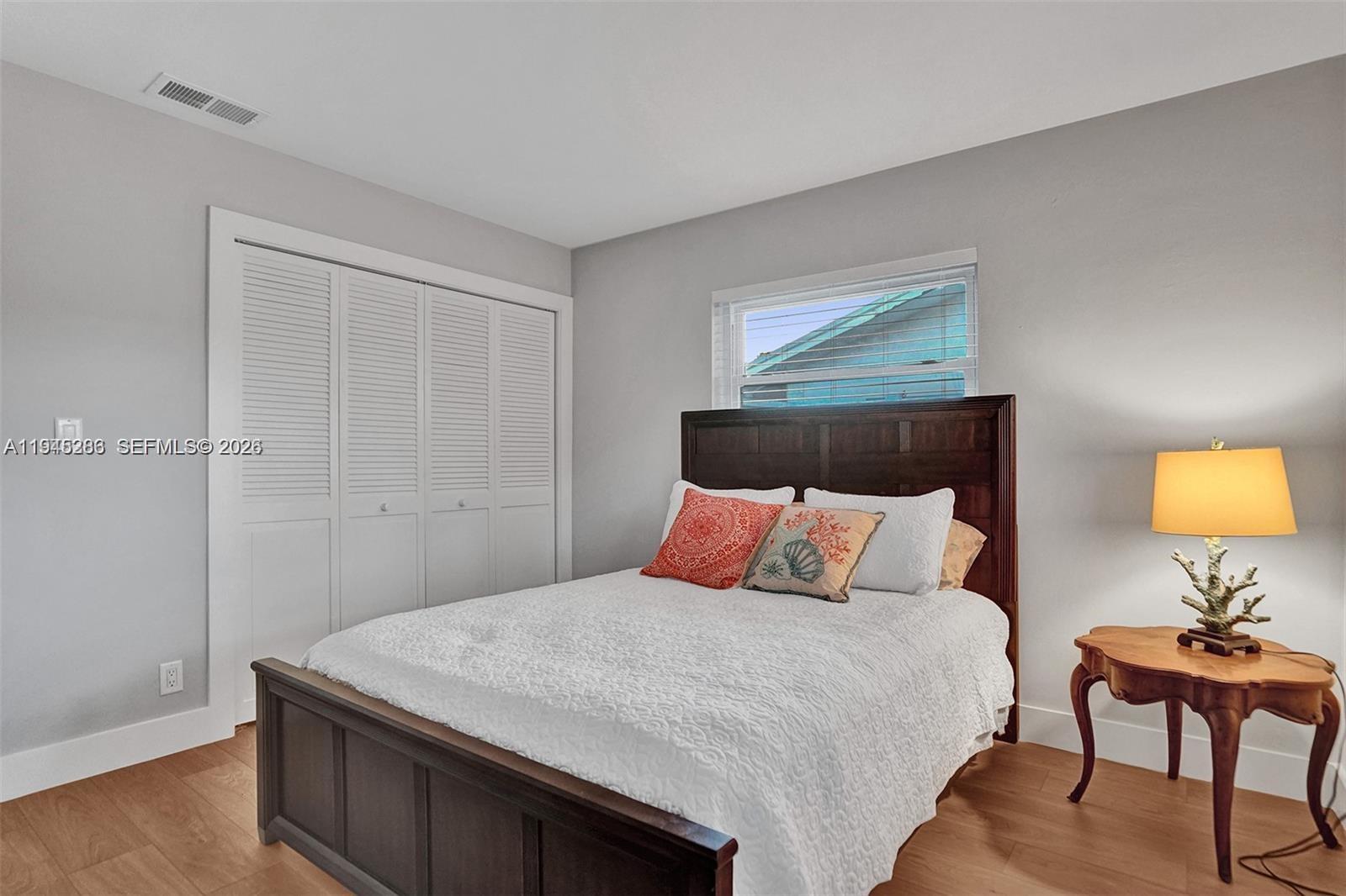 620 West Palmetto Park Road Boca Raton, FL 33486 - Photo 28 of 38 a bedroom with a bed and a lamp on dresser