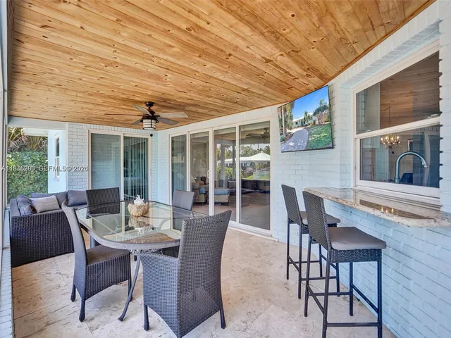 a dining room with furniture window and wooden floor