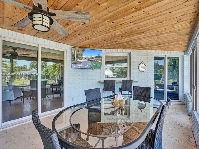 a dining room with furniture wooden floor and a rug