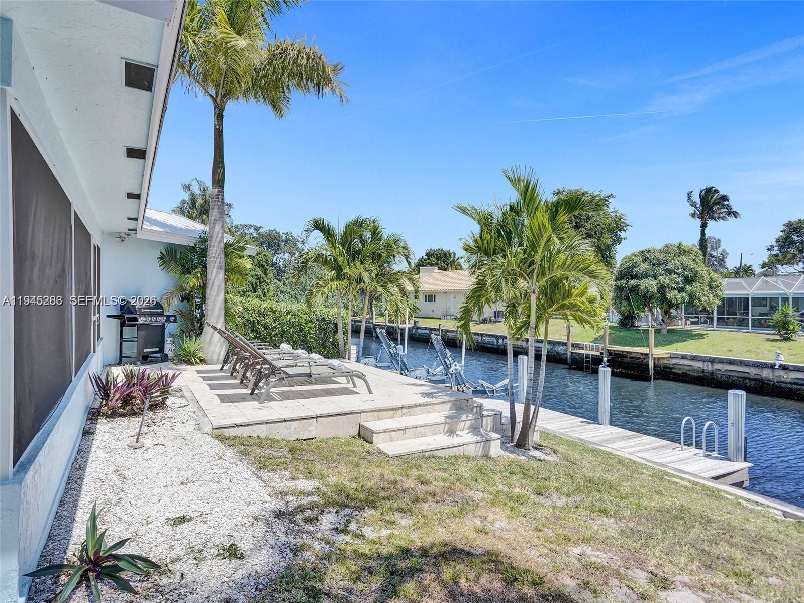 620 West Palmetto Park Road Boca Raton, FL 33486 - Photo 37 of 38 a view of a swimming pool with a patio and plants