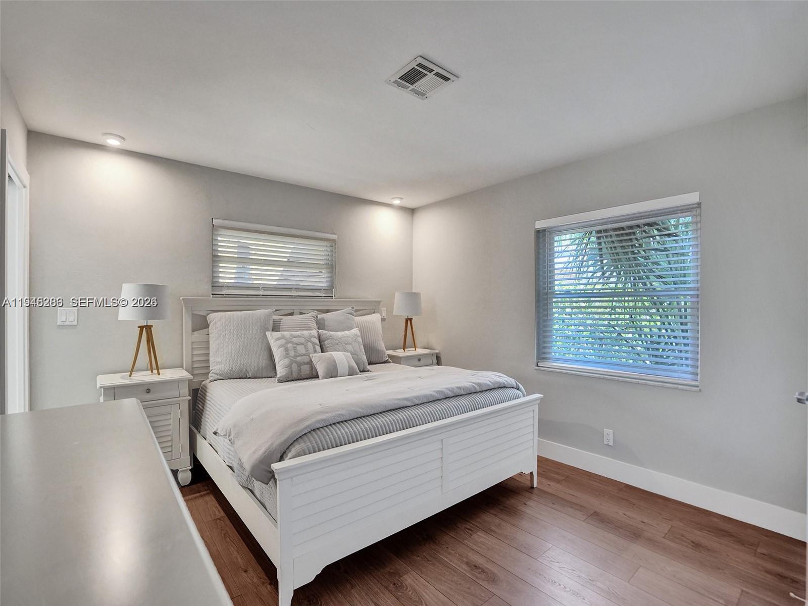 620 West Palmetto Park Road Boca Raton, FL 33486 - Photo 9 of 38 a bedroom with a bed and a night stand