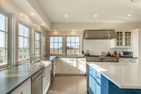 a open kitchen with stainless steel appliances granite countertop a lot of cabinets and wooden floor