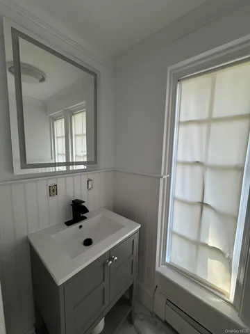 a bathroom with a sink and a window