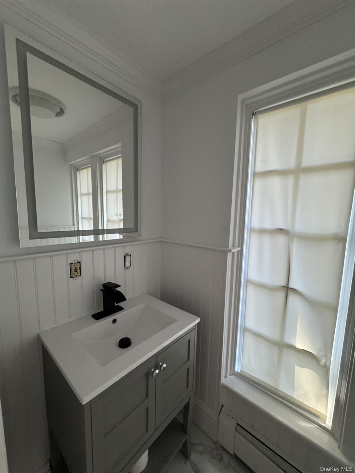 506 Midland Avenue Rye, NY 10580 - Photo 11 of 15 a bathroom with a sink and a window