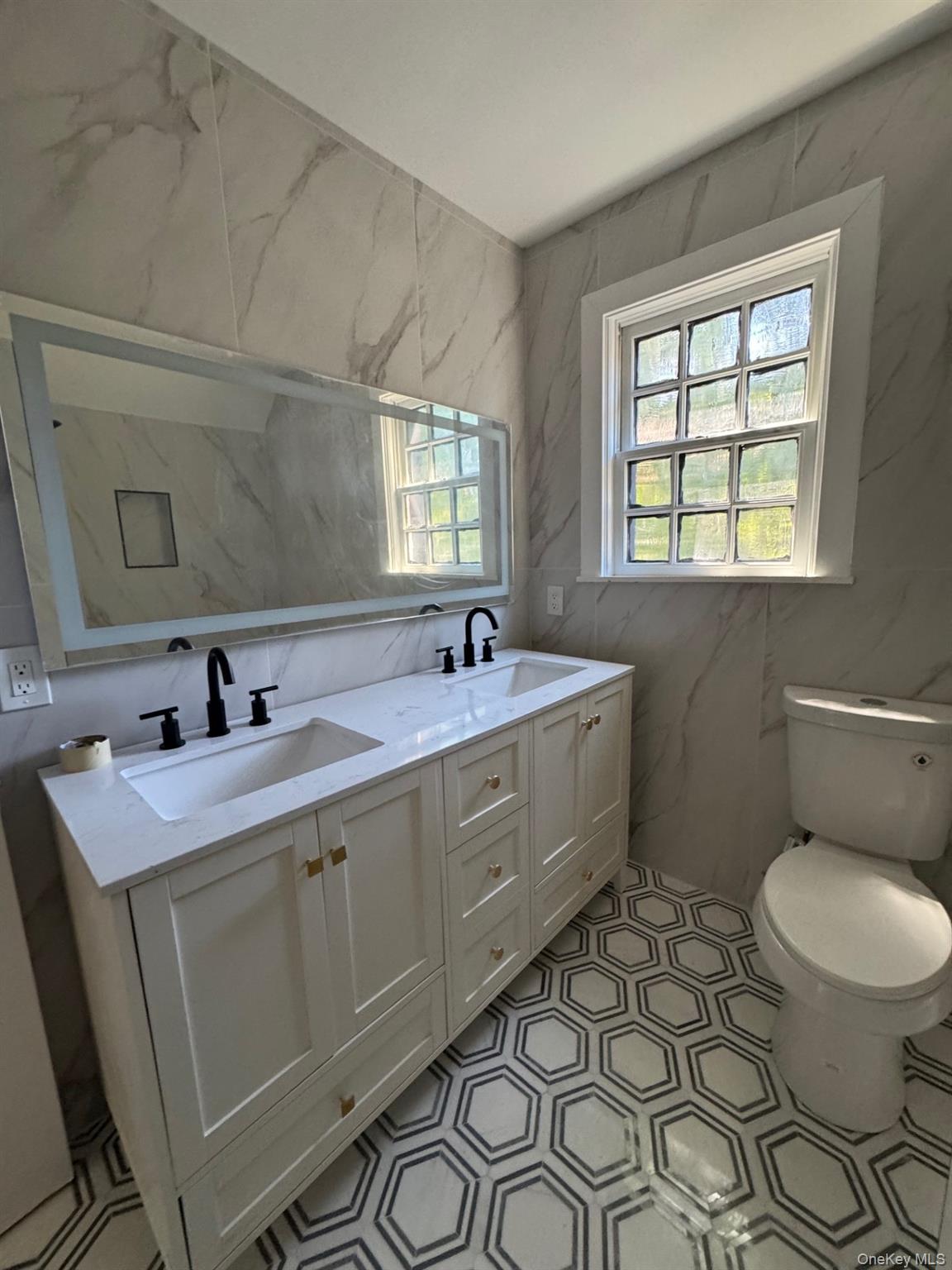 506 Midland Avenue Rye, NY 10580 - Photo 12 of 15 a bathroom with a double vanity sink toilet mirror and window