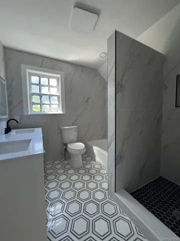 a bathroom with a sink toilet and shower