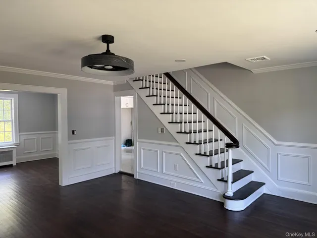 a view of entryway and hall with wooden floor