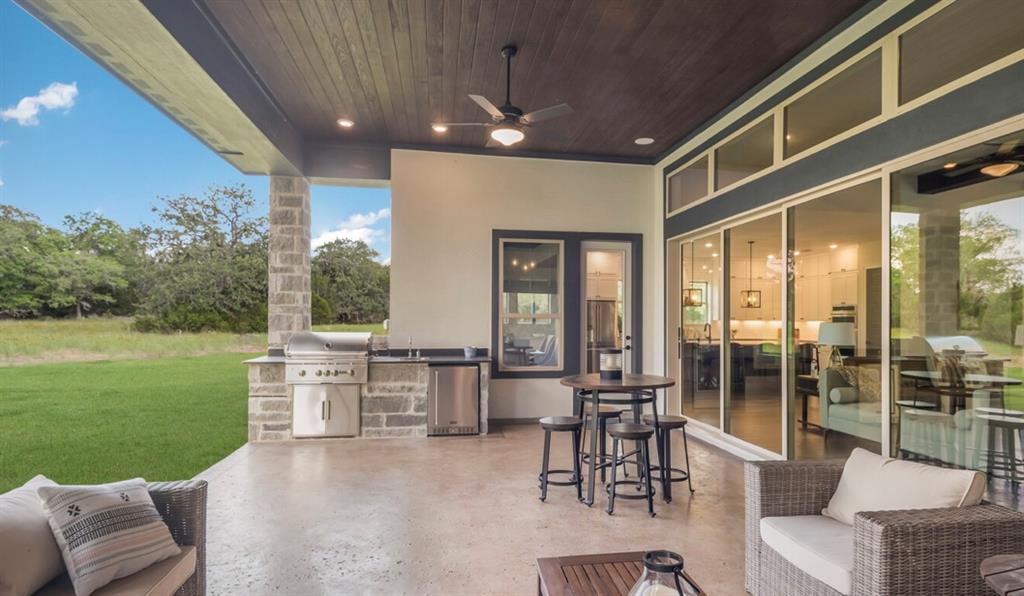 Lot 12 Ridgeway Trail Johnson City, TX 78636 - Photo 16 of 26 a living room with furniture floor to ceiling window and an outdoor view