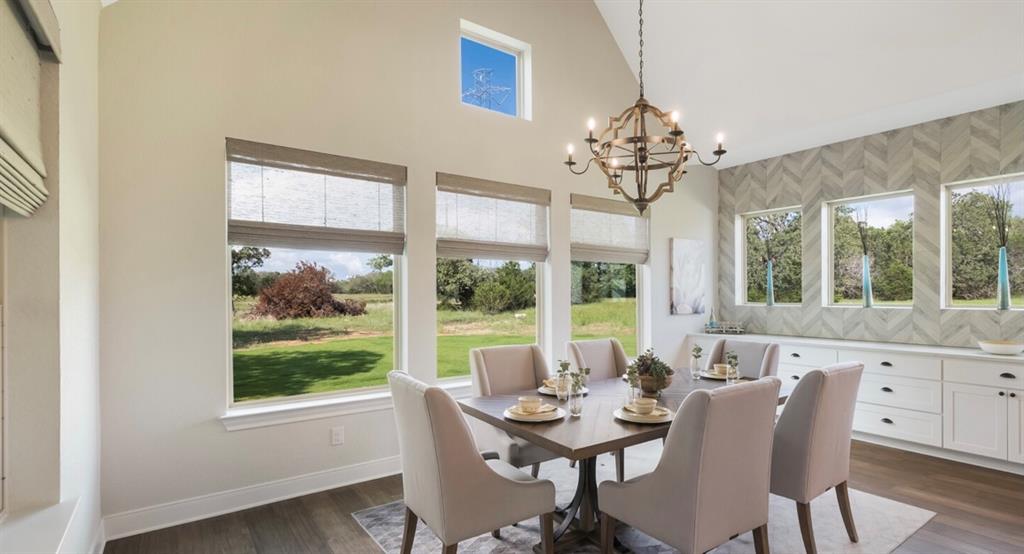 Lot 12 Ridgeway Trail Johnson City, TX 78636 - Photo 7 of 26 a view of a dining room with furniture a chandelier and wooden floor