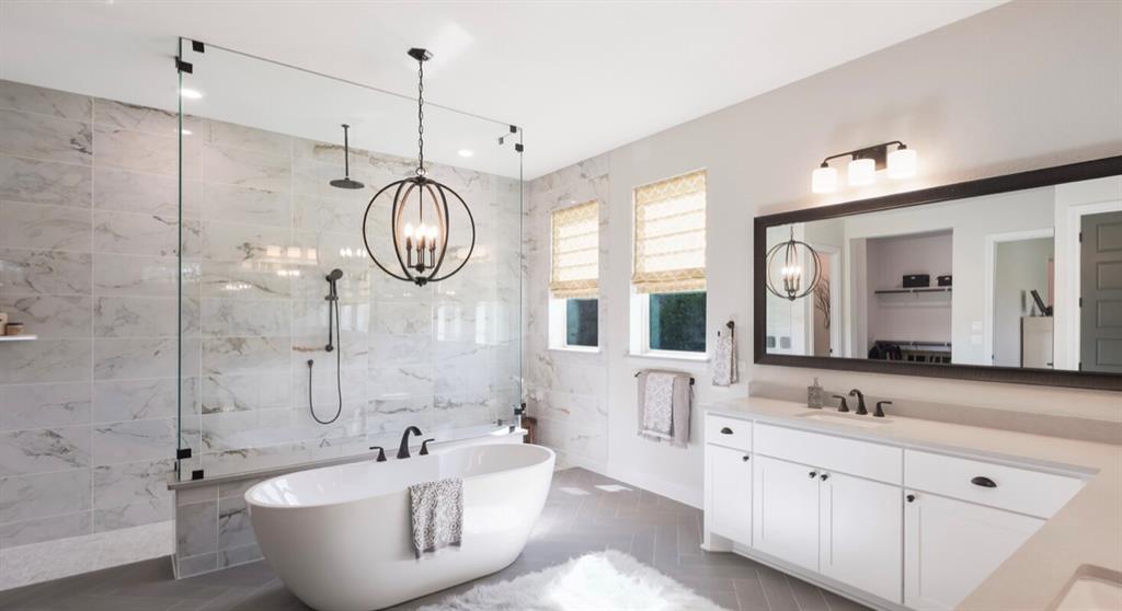 Lot 12 Ridgeway Trail Johnson City, TX 78636 - Photo 10 of 26 a spacious bathroom with a bathtub a sink and a large mirror