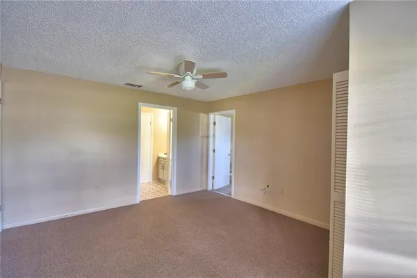 a view of a livingroom with a chandelier fan